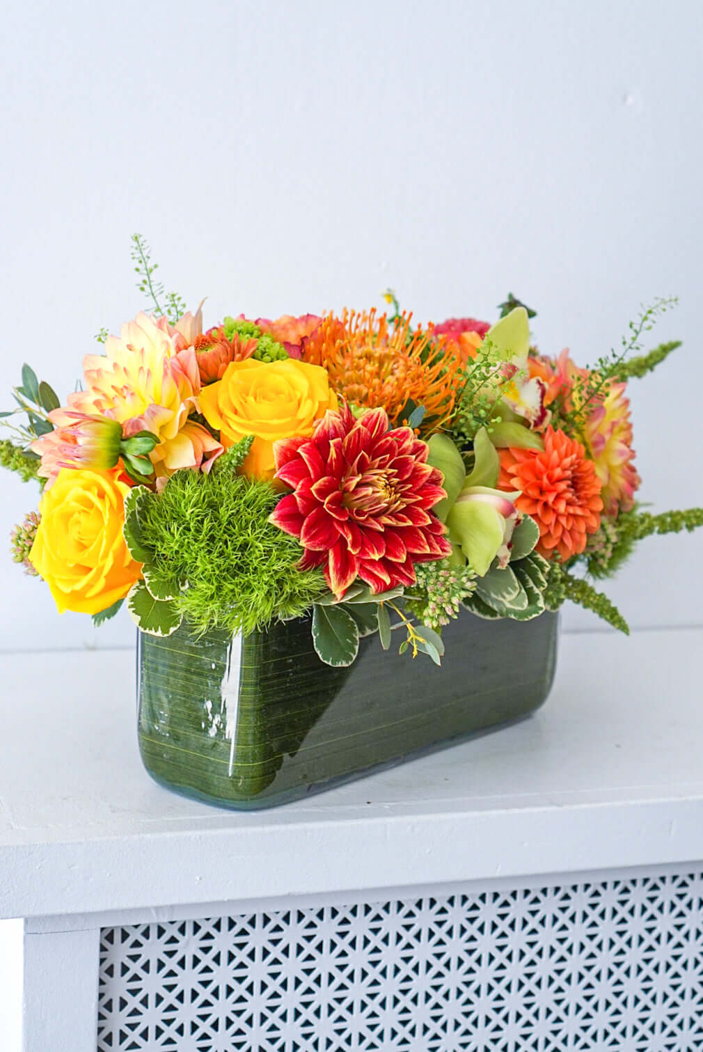 Harvest Centrepiece - Make fall shimmer with this glorious assorted of autumnal blooms, arranged in a modern rectangular vase.