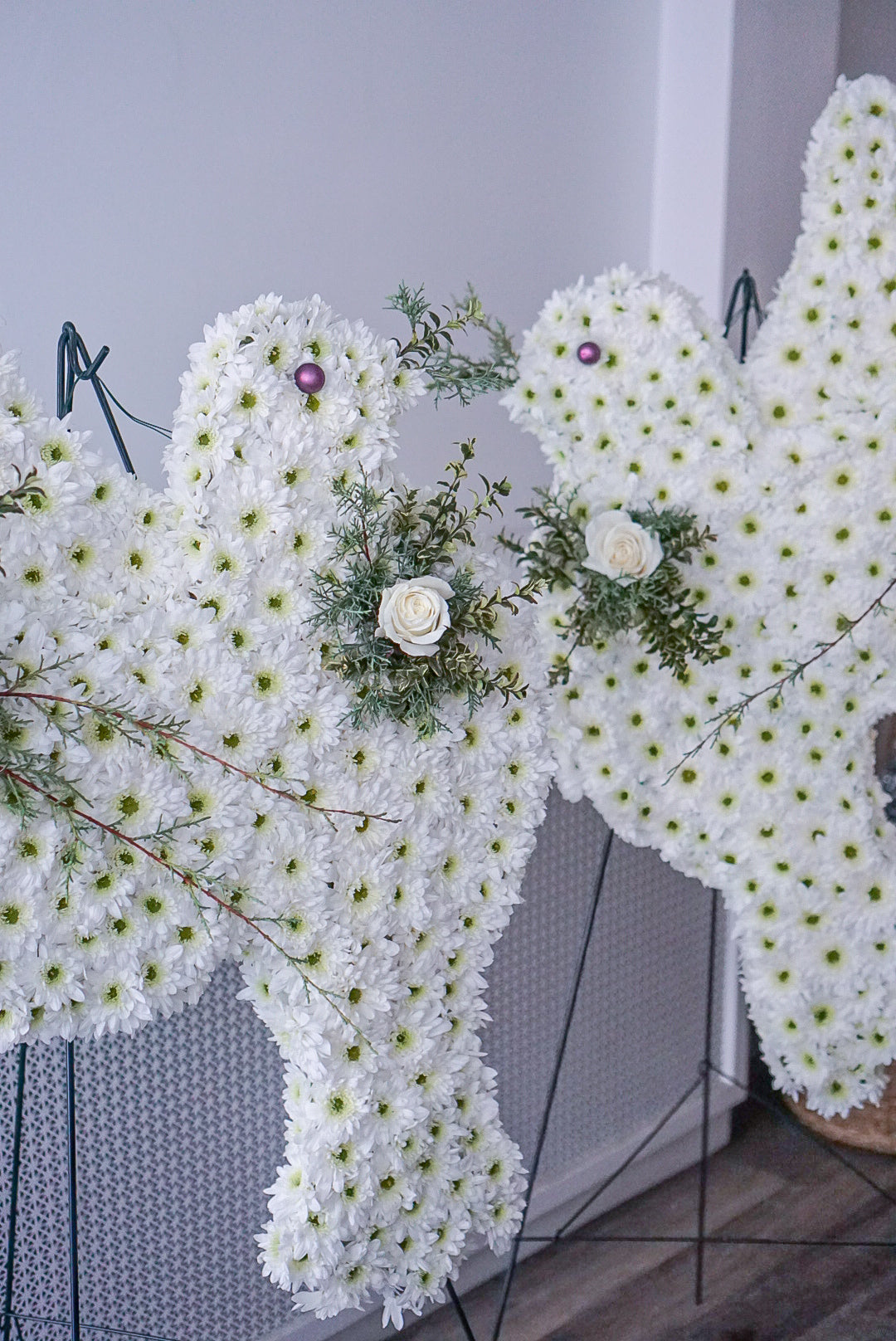 Sympathy flowers Toronto - memorial tribute shaped like white doves made of chrysanthemums and roses for remembrance.