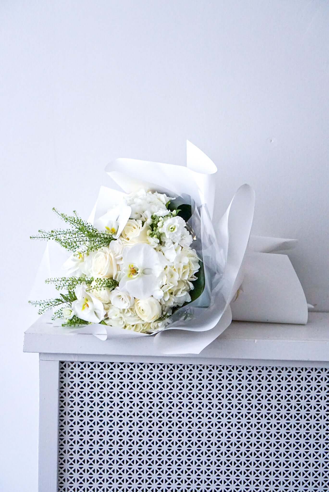 Turn on the charm with this elegant white and cream bouquet. The flowers are gift wrapped and package in water to last for the day.