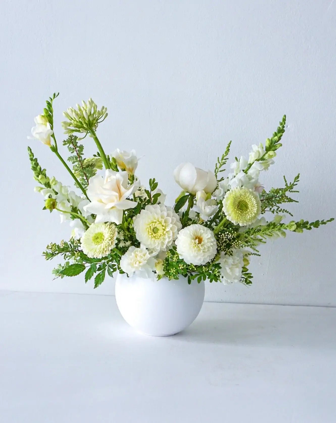 A stylish array of the seasons best crisp white and cream blooms in white bowl - an elegant gift for any occasion. We offer same-day or next-day delivery thought out Toronto and GTA. Toronto Flower Delivery- The Flower Nook- Toronto Florist