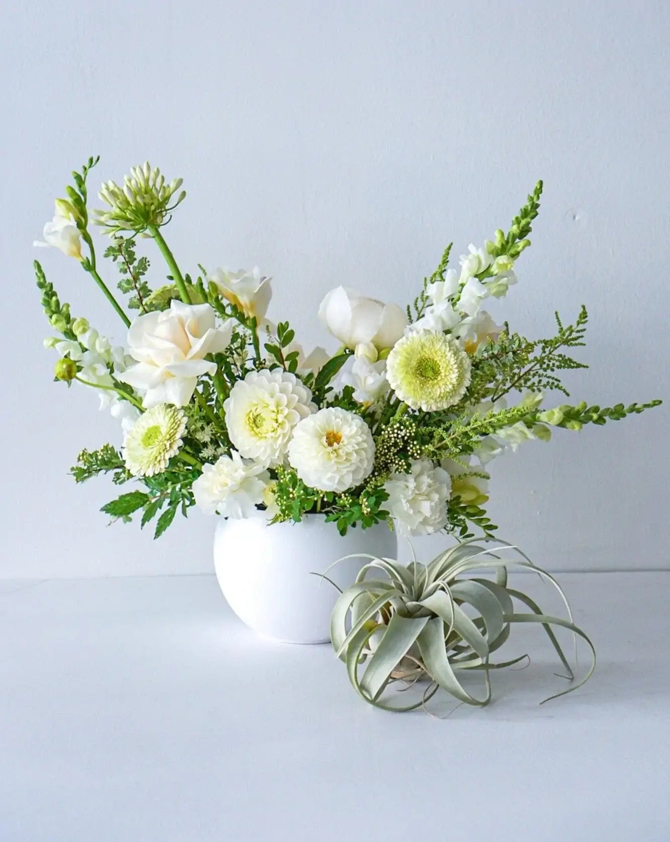 A stylish array of the seasons best crisp white and cream blooms in white bowl - an elegant gift for any occasion. We offer same-day or next-day delivery thought out Toronto and GTA. Toronto Flower Delivery- The Flower Nook- Toronto Florist