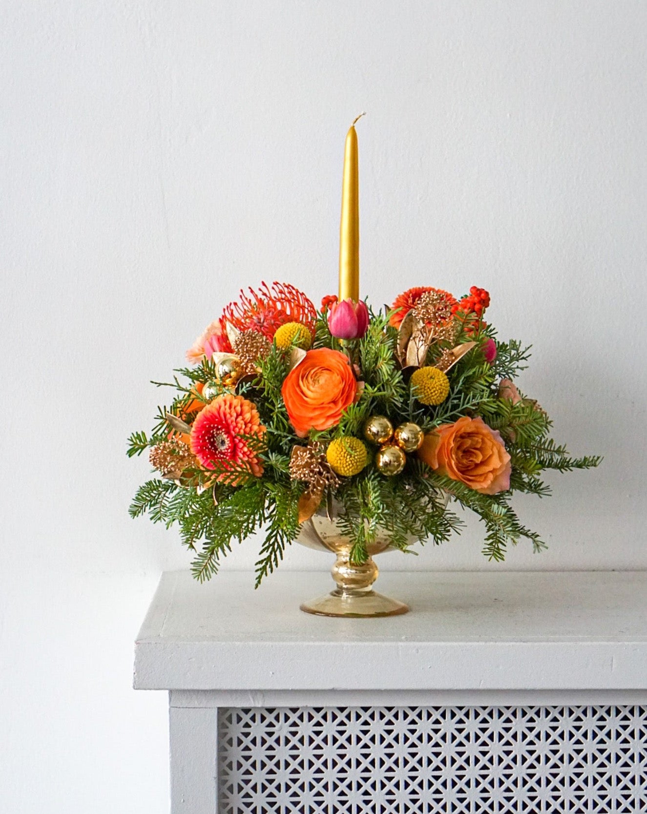 An arrangement that evokes that warm and fuzzy feelings. Featuring pin cushions, gerbpom, free spirit roses, ranunculus, double tulips, golden ilex, golden sprayed skimmia.The Flower Nook. Toronto Florist