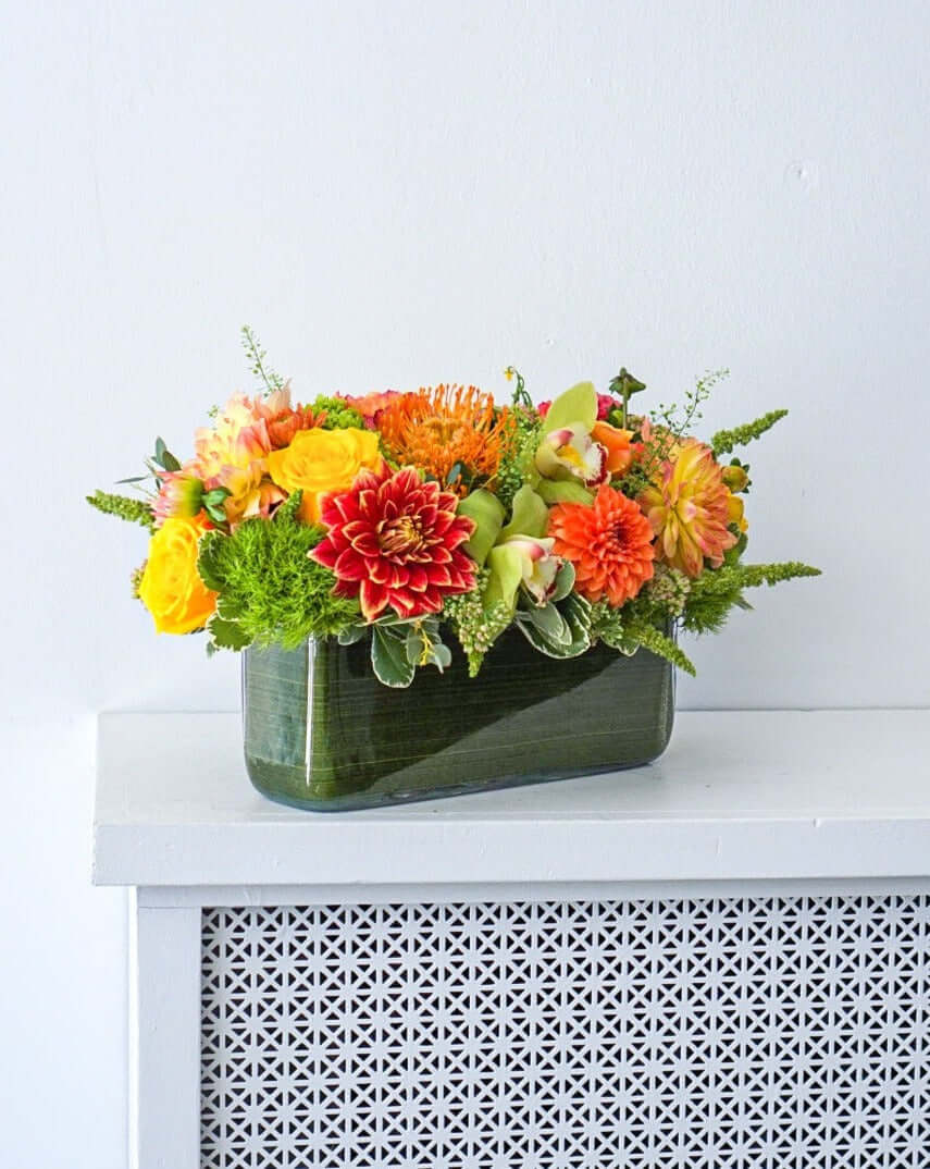 Harvest Centrepiece - Make fall shimmer with this glorious assorted of autumnal blooms, arranged in a modern rectangular vase.