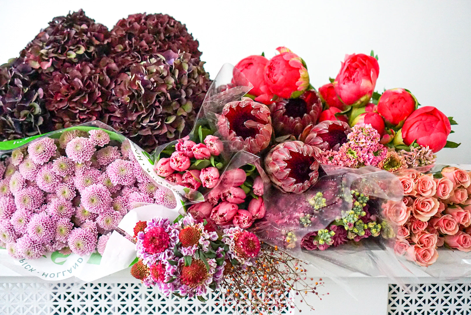 Assorted premium flowers in vibrant colors including premium blooms for floral arrangements.