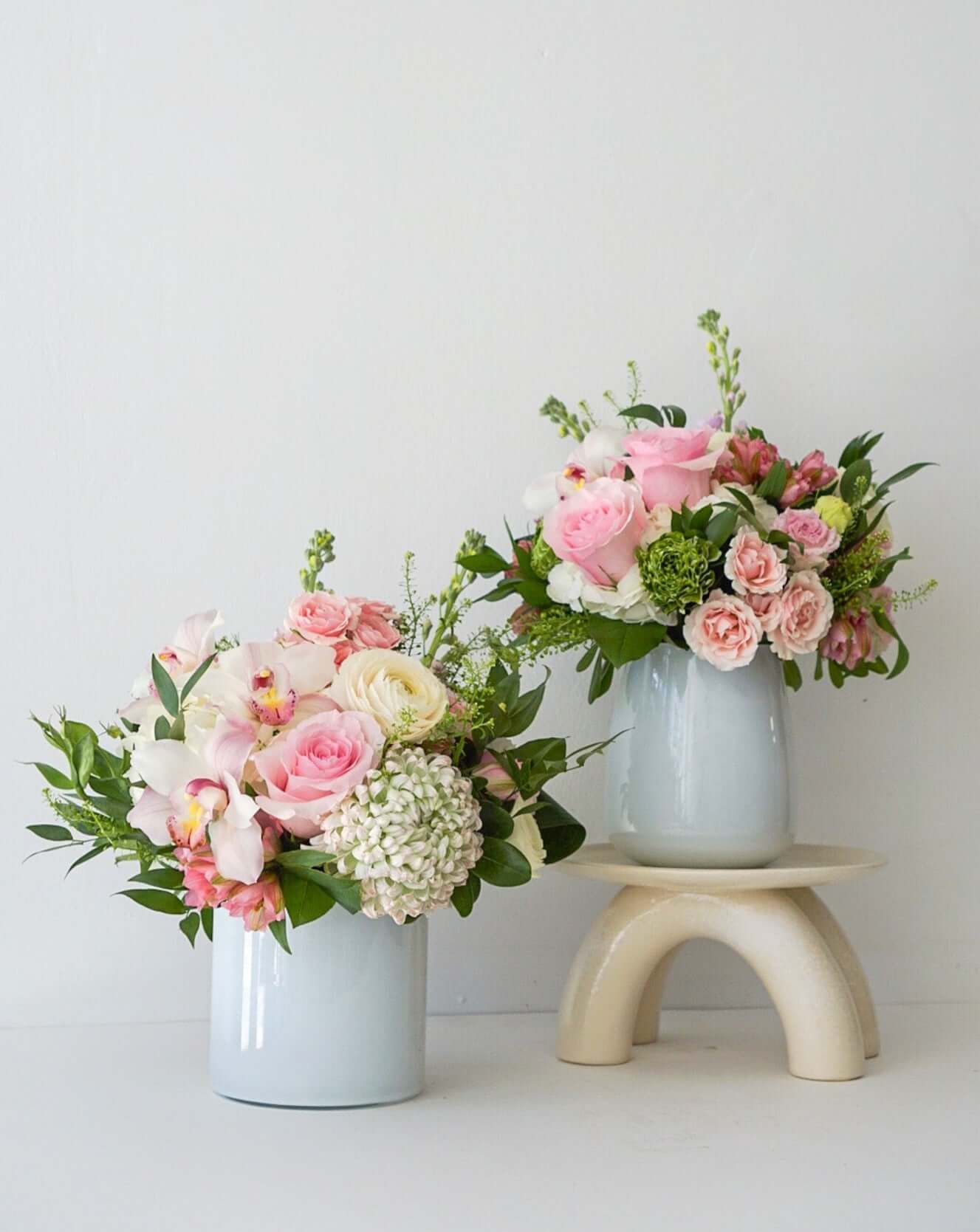 Divine pretty pastels artfully styled in our white glass vases. Approx. Overall Dimensions: 10"L x 10"H. Base Dimensions: Standard - 4.25" x 6.75". Premium 7.5" x 7.5"