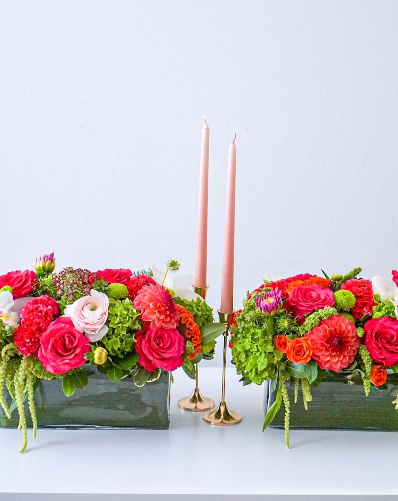 A centrepiece full of the fall's best blooms. Featured: green hydrangeas, free spirit roses, dahlias, cymbidium orchids, spray roses, designed in a 12" rectangle clear glass leaf-lined cylinder.