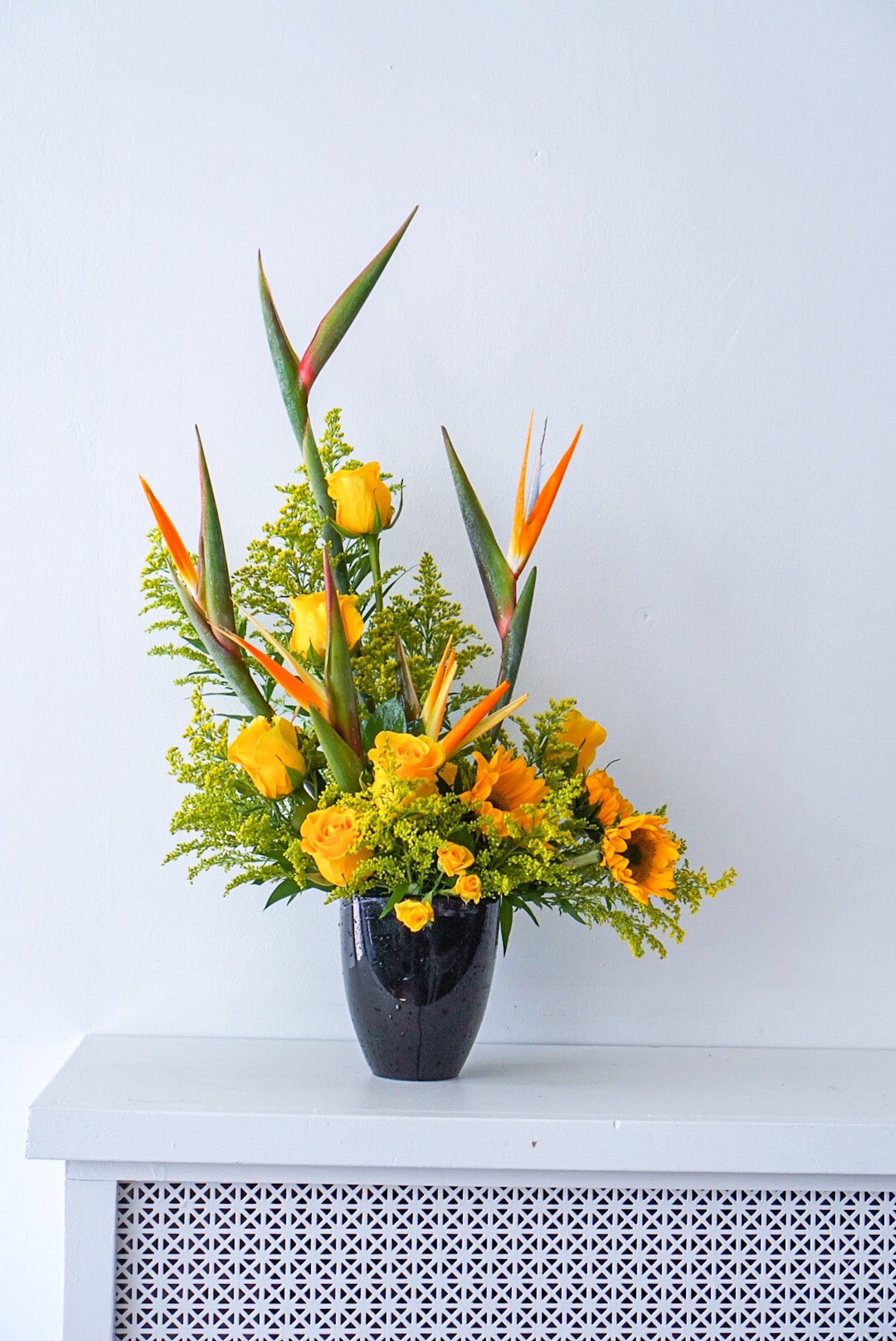 Send sun and paradise someone's way with this striking arrangement. We offer same-day and next-day delivery through out Toronto and GTA. This arrangement features Birds of Paradise, Sun flowers, Yellow Roses, Yellow Solidago- The Flower Nook - Toronto Flower Delivery - Toronto Florist