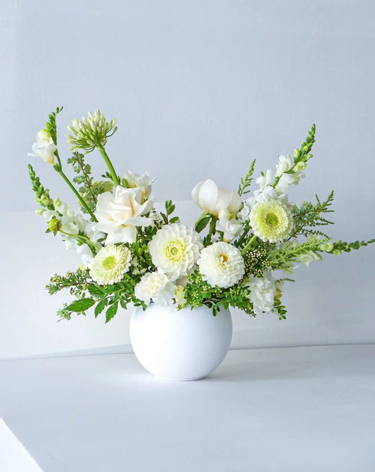 A stylish array of the seasons best crisp white and cream blooms in white bowl - an elegant gift for any occasion. We offer same-day or next-day delivery thought out Toronto and GTA. Toronto  Flower Delivery- The Flower Nook- Toronto Florist 