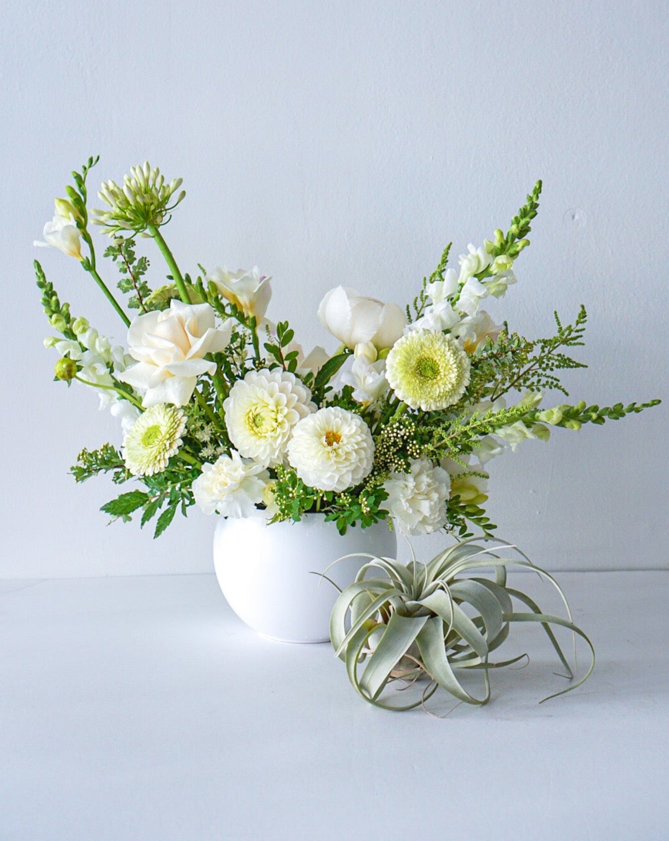 A stylish array of the seasons best crisp white and cream blooms in white bowl - an elegant gift for any occasion. We offer same-day or next-day delivery thought out Toronto and GTA. Toronto  Flower Delivery- The Flower Nook- Toronto Florist 