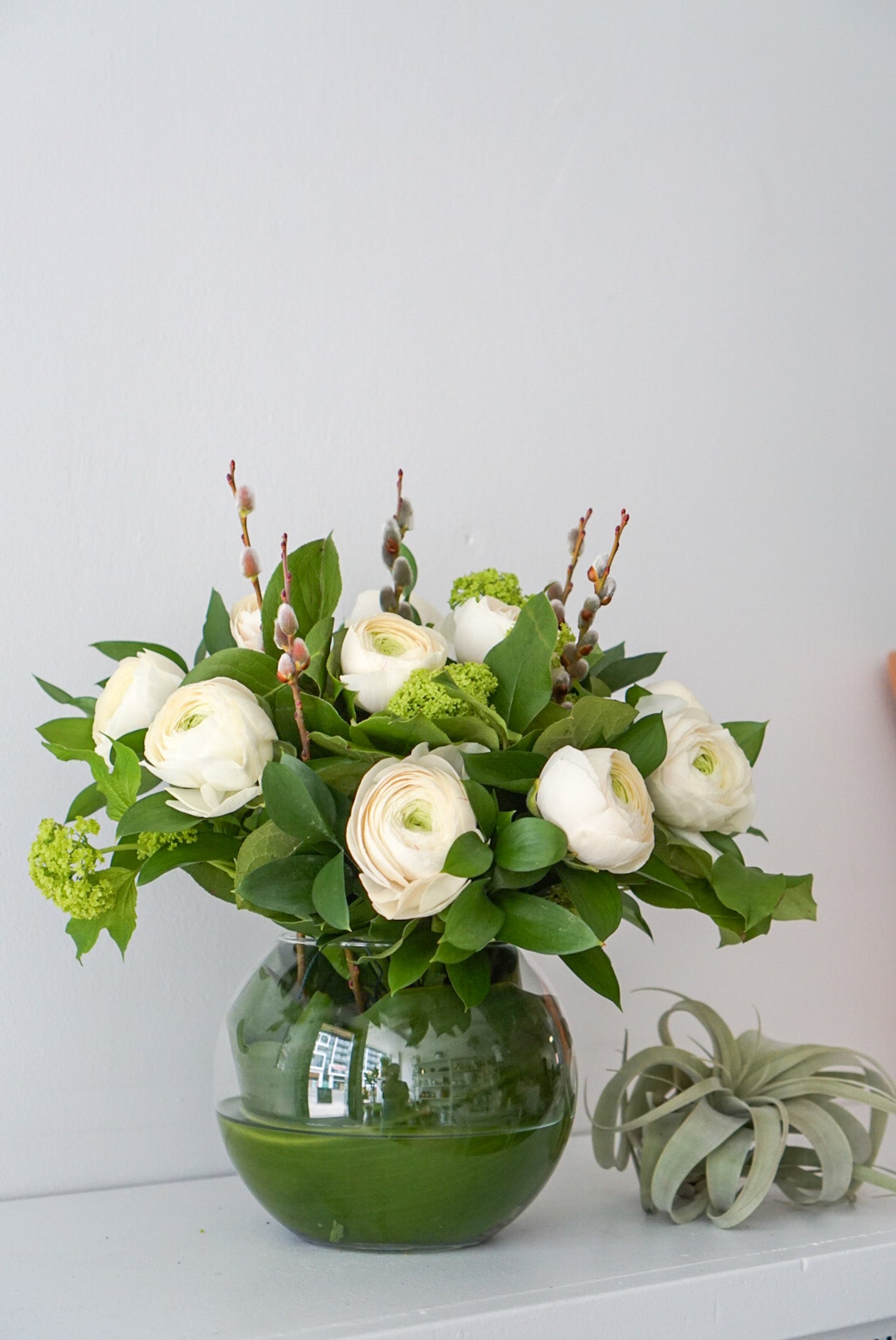 This elegant, feminine arrangement is made of 10 soft, magnificent ranunculus. They are beautifully arranged in a 6" fish bowl.