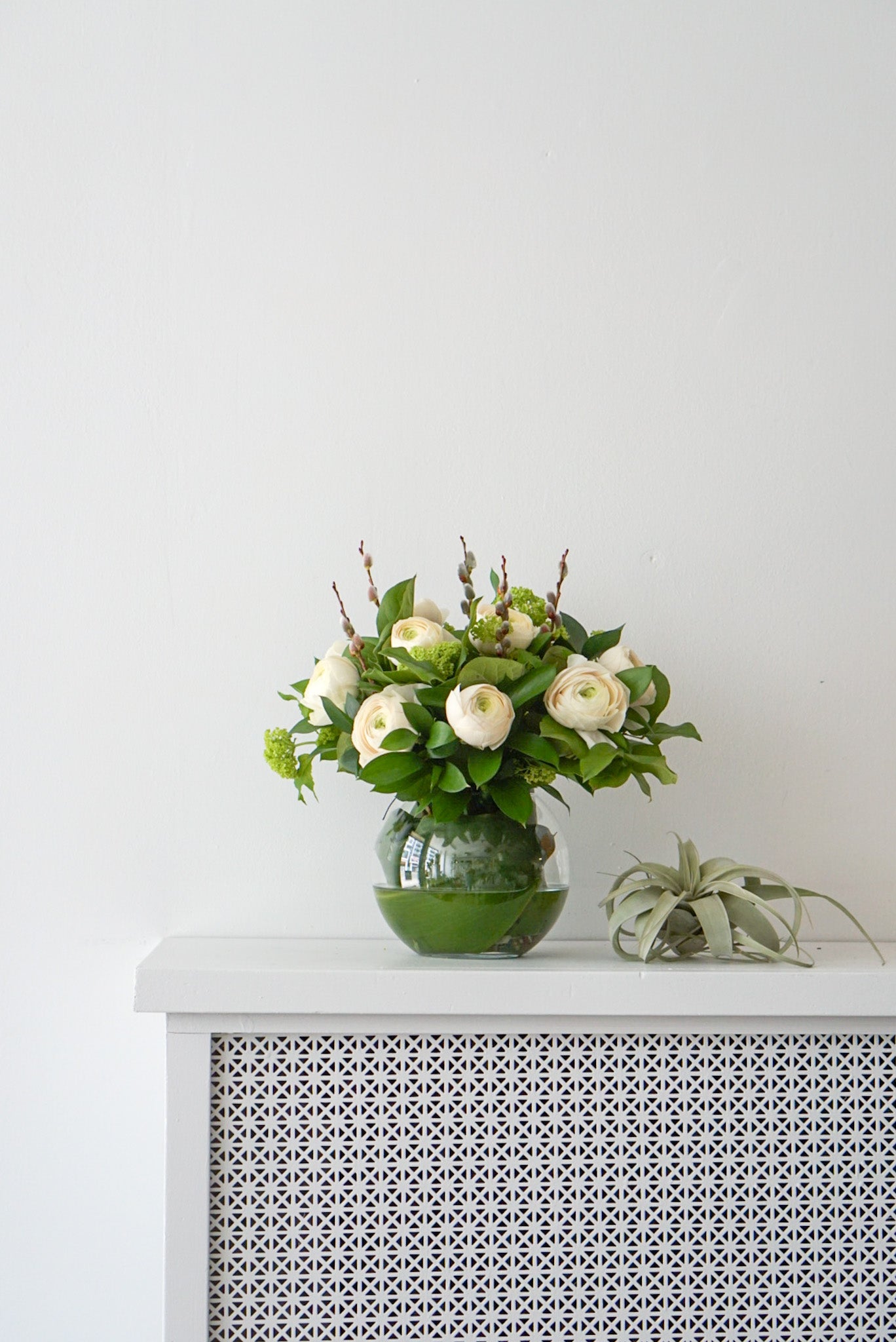 This elegant, feminine arrangement is made of 10 soft, magnificent ranunculus. They are beautifully arranged in a 6" fish bowl.