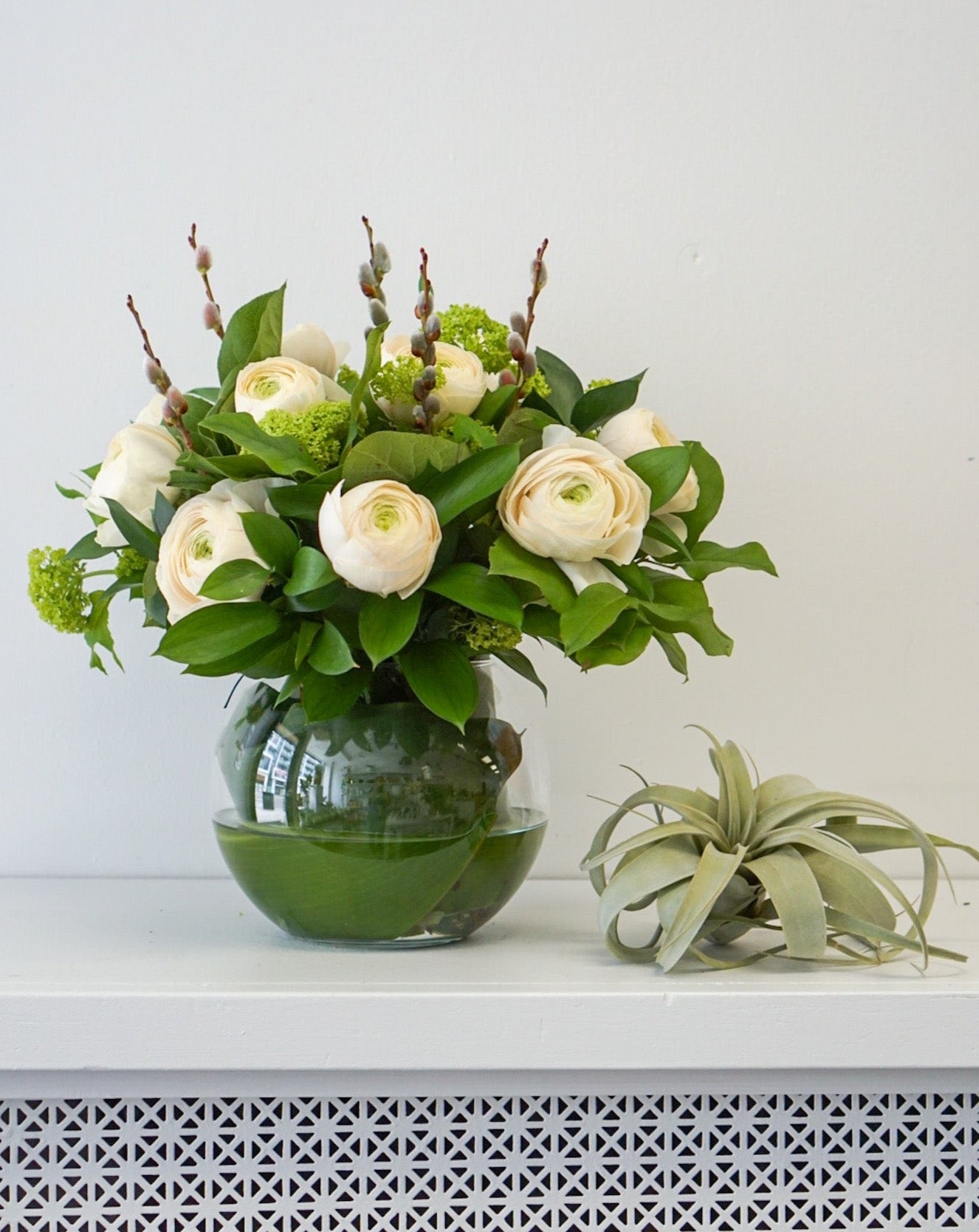 This elegant, feminine arrangement is made of 10 soft, magnificent ranunculus. They are beautifully arranged in a 6" fish bowl.