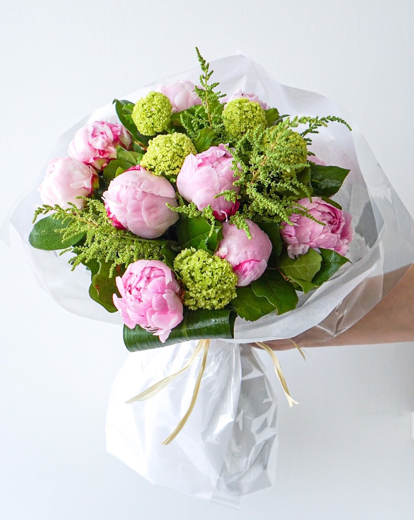 PEONIES are in season now and they are beautiful! Everyone loves the lush, cloud-like appearance of fresh cut peonies.  This simple bouquet of these lovely blooms is perfect gift for a friend or yourself.  We offer them in two styles:  Hand-tied bouquet that is ready to be pop into a vase at home Already designed in a fish bowl 