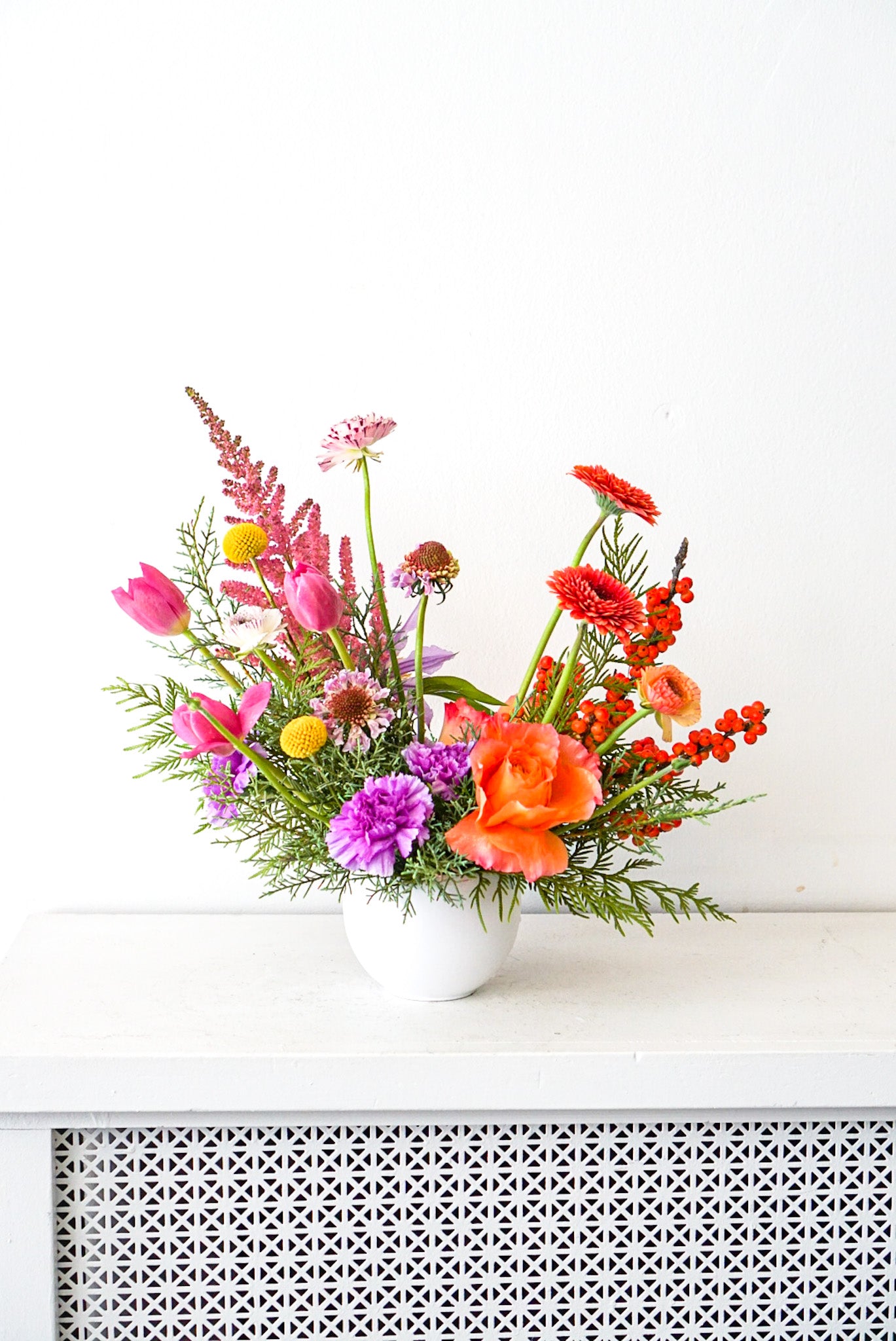 Sun Valley - An elegant modern arrangement featuring peaks of colourful and unique blooms, such as astilbe, free spirit roses, scabiosa, tulips, ilex, carnations, gerbpom. The Flower Nook. Toronto Florist