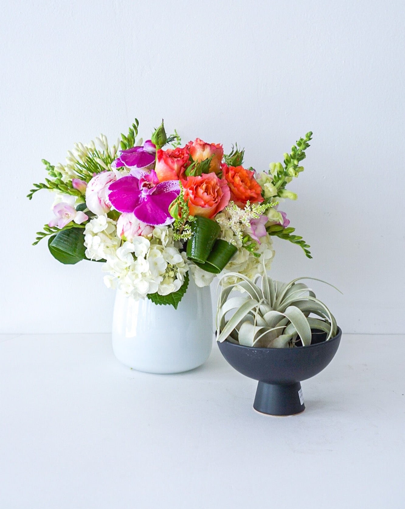 As glorious as the sunrise, this mix of hydrangeas, roses, orchids in white taper glass vase&nbsp;radiates joy. We offer same-day and next-day delivery thought out GTA and Toronto. Toronto Flower Delivery- The  Flower Nook - Toronto Florisr