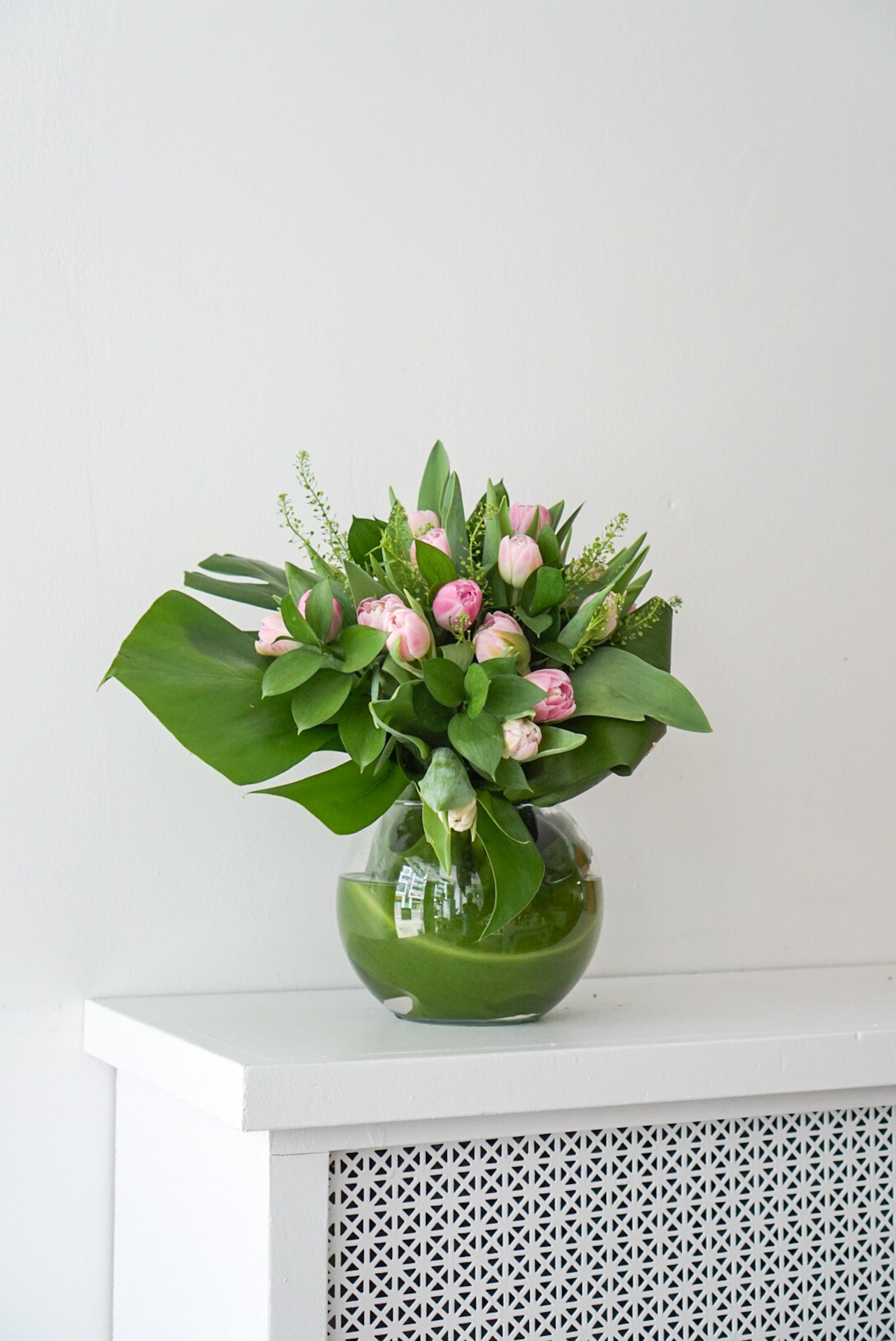  A design of premium double Dutch tulips and presentation that highlight tulips' natural beauty. This arrangement is the perfect gift for your lover, friend, or someone special that loves Tulips.  Approx. Overall Dimensions: 11"L x 12"H. Base Dimensions: 6" x 8" 